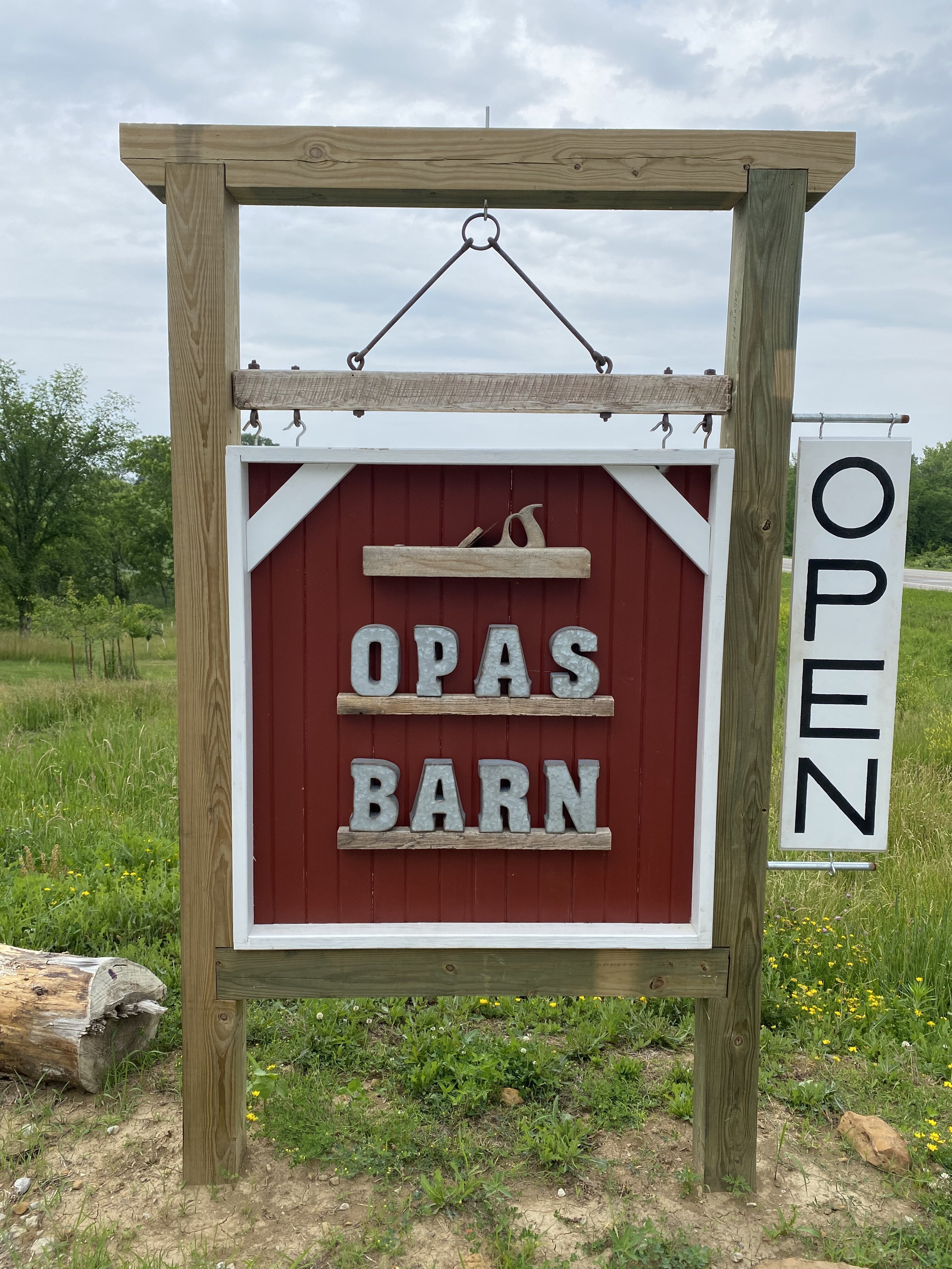 Open sign stating the name Opa's Barn